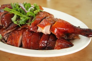 Roast duck chinese cuisine sliced portions on plate